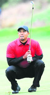 Tiger Woods watches his fairway shot to the 18th green in regulation play during the final round of the Chevron World Challenge in California