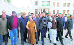 Congress leaders raise slogans against the government in front of the Vidhan Sabha in Dharamsala
