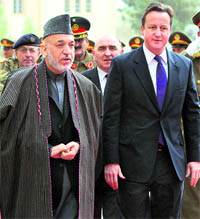 Afghanistan President Hamid Karzai (left) and Britain's Prime Minister David Cameron review a guard of honour in Kabul on Tuesday