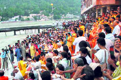 Devotees at the Parmarth Niketan perform Ganga aarti in Rishikesh on Wednesday