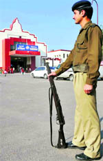 a policeman stands guard at the deserted railway station in Haridwar