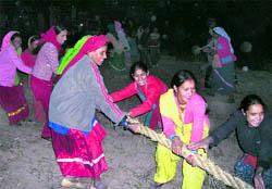 Women of Bhatoli village compete with men in a tug-of-war on Divali