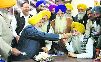 Minister for the Jails, Tourism and Cultural Affairs Hira Singh Gabria (blue coat) and SAD functionaries celebrate the birthday of Chief Minister Parkash Singh Badal in Ludhiana on Wednesday
