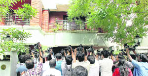Lensmen outside the house of a Raja aide during a CBI raid in Chennai on Wednesday.