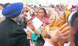 Deputy Chief Minister Sukhbir Singh Badal listens to grievances during sangat darshan in Kotbhai village, near Gidderbaha, on Wednesday.