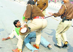 A resident of Colony No 5. at the receiving end after rioters began throwing stones at passersby. Several vehicles were damaged in the disturbance