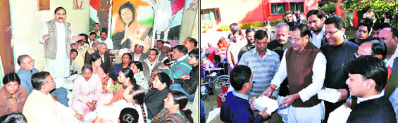 A meeting of the Congress unit in progress in Haridwar; and (right) Yashpal Arya, Uttarakhand Congress chief, distributes sweets among inmates of Raphael Home on Sonia Gandhis birthday in Dehradun on Thursday.