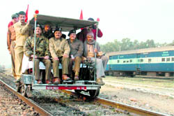 Railway officers inspect the Udhampur-Jammu track on a trolley on Thursday
