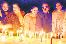 Residents light candles on the eve of International Human Rights Day in Bathinda on Thursday. 