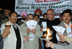 Members of the International Human Rights Organisation at a torch march near Arya Samaj Chowk in Bathinda on Friday