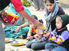 Devotees partake of langar on the Martyardom Day of Guru Teg Bahadur at a gurdwara in Sector 34, Chandigarh, on Friday.