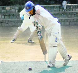 A batsman plays a defensive stroke in the Senior Council Cricket Tournament at St Josephs Academy in Dehradun on Friday.