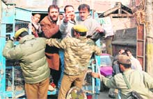 Policemen detain JKLF activists during a demonstration in Srinagar on Friday. 