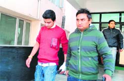 One of the students (on the left) of GGM Science College, who was injured after being attacked by a classmate, at hospital in Jammu on Friday. 