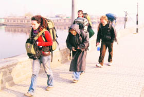 Foreign tourists walk along the Dal Lake in Srinagar.