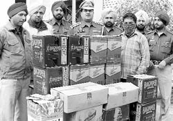 The accused, along with liquor cartons, in police custody in Ludhiana on Friday