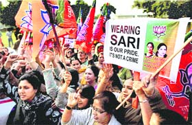 BJP supporters hold a placard and shout slogans during a protest against the pat down of Indian Ambassador to the US Meera Shankar by US airport security officials, outside the American Embassy in New Delhi on Friday.