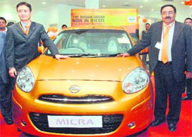 Satoshi Matsutomi (L), Vice-President, Nissan Motor India and Dinesh Jain, CEO, Hover Automotive India, poses with diesel-powered Micra at its launch in New Delhi
