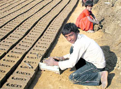 Minor children work at a brick-kiln near Katesara village in Rohtak