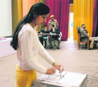 A student casts her vote at HPU in Shimla on Saturday.