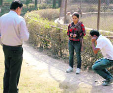 An official of the anti-goonda staff punishes a boy at a garden in Patiala.