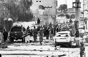 Security personnel inspect the blast site in Kandahar on Saturday.