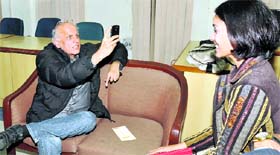 Producer-cum director Mahesh Bhatt clicks pictures during a function at Management Development Institute in Gurgaon on Sunday.