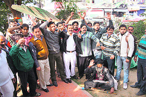 Residents of Gandhi Nagar hold a demonstration against an anti-encroachment drive in Jammu on Sunday.