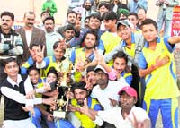 The winners of the T20 cricket meet with the trophy in Ludhiana on Sunday. 