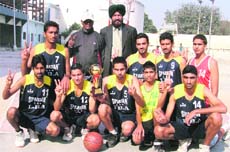 The winners of the basketball championship with the trophy in Ludhiana.