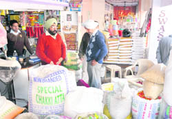 Officials check goods in a grocery store at Dadu Majra colony in Chandigarh 