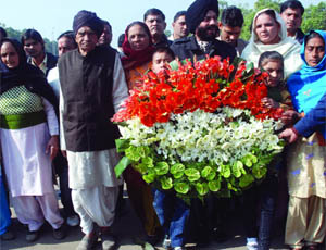 Family members of the 2001 Parliament attack victims with All-India Anti-Terrorist Front chairman M.S. Bitta pay homage to the martyrs at Amar Jawan Jyoti at the India Gate in New Delhi on Monday.