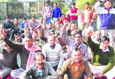 Roadways workers hold a dharna in Haridwar on Monday.