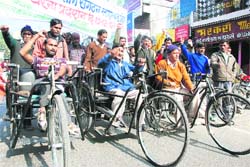 Physically challenged persons take out a rally in Dehradun on Monday. 