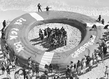 Greenpeace activists protest next to a giant life ring during talks on climate change in Cancun.