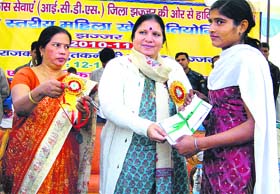 Haryana Minister Geeta Bhukkal gives away a prize to a winner during the district-level women sports competition in Jhajjar