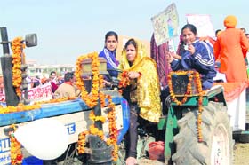 Kavita Abbot, a teacher from Murlidhar DAV Public School, drives a tractor in the Jan Chetna Yatra