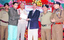 ADGP ,Home Guards,Civil Defence and Auxiliary Police,J&K,S.Gopal Reddy presents a certificate to a volunteer at the end of a six-day training camp organised by the Civil Defence Organisation,Udhampur,on Monday. 
