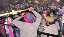 Policemen try to disperse a crowd during a show at PAU in Ludhiana by actor Akshay Kumar and actress Katrina Kaif late on Sunday night.