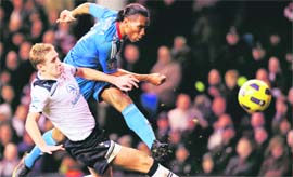 Didier Drogba (in blue) shoots to score the equalising goal on Sunday.