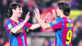 Barcelona's Bojan Krkic (R) celebrates with Lionel Messi (L) after scoring against Real Sociedad at the Camp Nou in Barcelona on Sunday. Barcelona won 5-0.
