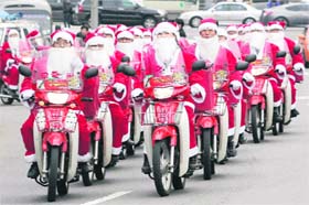 MISSION CHARITY: South Korean postmen dressed as Santa Claus leave the post office headquarters to deliver Christmas gifts to poor people in Seoul