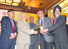 Officials of Punjab State Power Corporation Ltd receive an award for excellent performance of Guru Hargobind Thermal Plant, Lehra Mohabat from Union Power Minister Sushil Kumar Shinde (2nd from left) in New Delhi on Tuesday. 