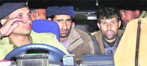 The two J&K militants arrested by the Dehradun police being taken to a court for transit remand in Dehradun on Tuesday.