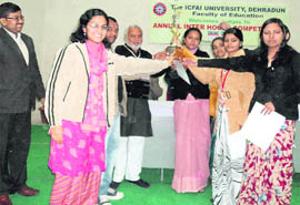 Winners of the inter-house singing competition of ICFAI University pose with the trophy in Dehradun on Tuesday.