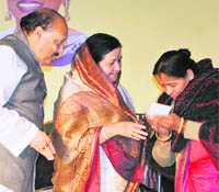 Bholeji Maharaj and Mata Mangla Devi present a cheque to Boksha Jan Jati Balika School in Dehradun on Tuesday.