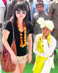 An MBA student from Canada interacts with a child at Banchari village in Palwal district