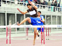 Girls take part in a hurdles race during the Punjab State Schools Athletics Meet in Ludhiana on Tuesday.