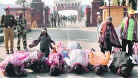 Indian fishermen, who were released from a Pakistan prison, kiss the ground on crossing over at the Attari-Wagah checkpost on Tuesday.