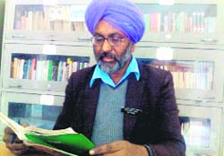 Surjeet Singh studies in the library of the Teachers Home in Bathinda on Tuesday.